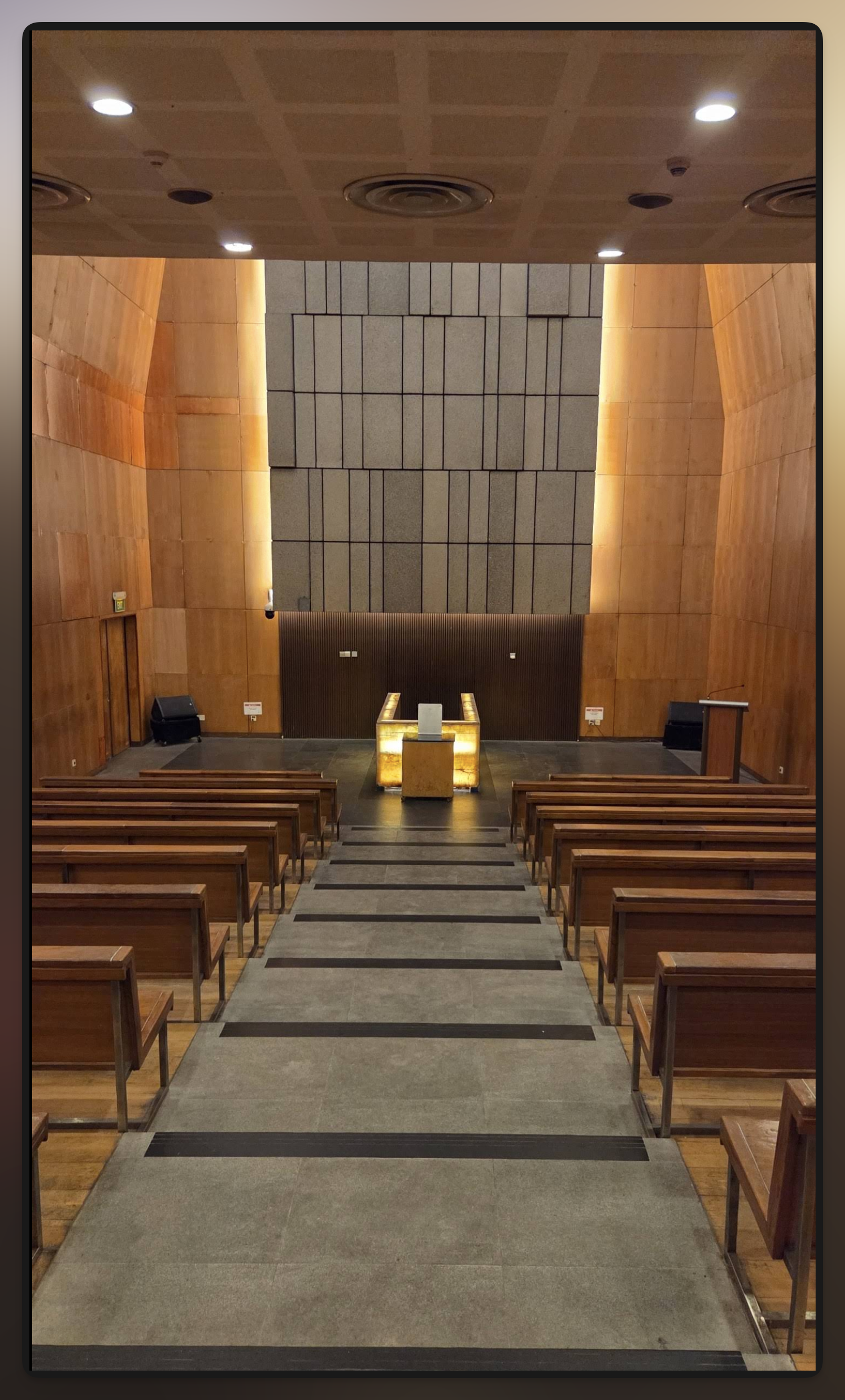 Crematorium service hall with seating facing the committal area