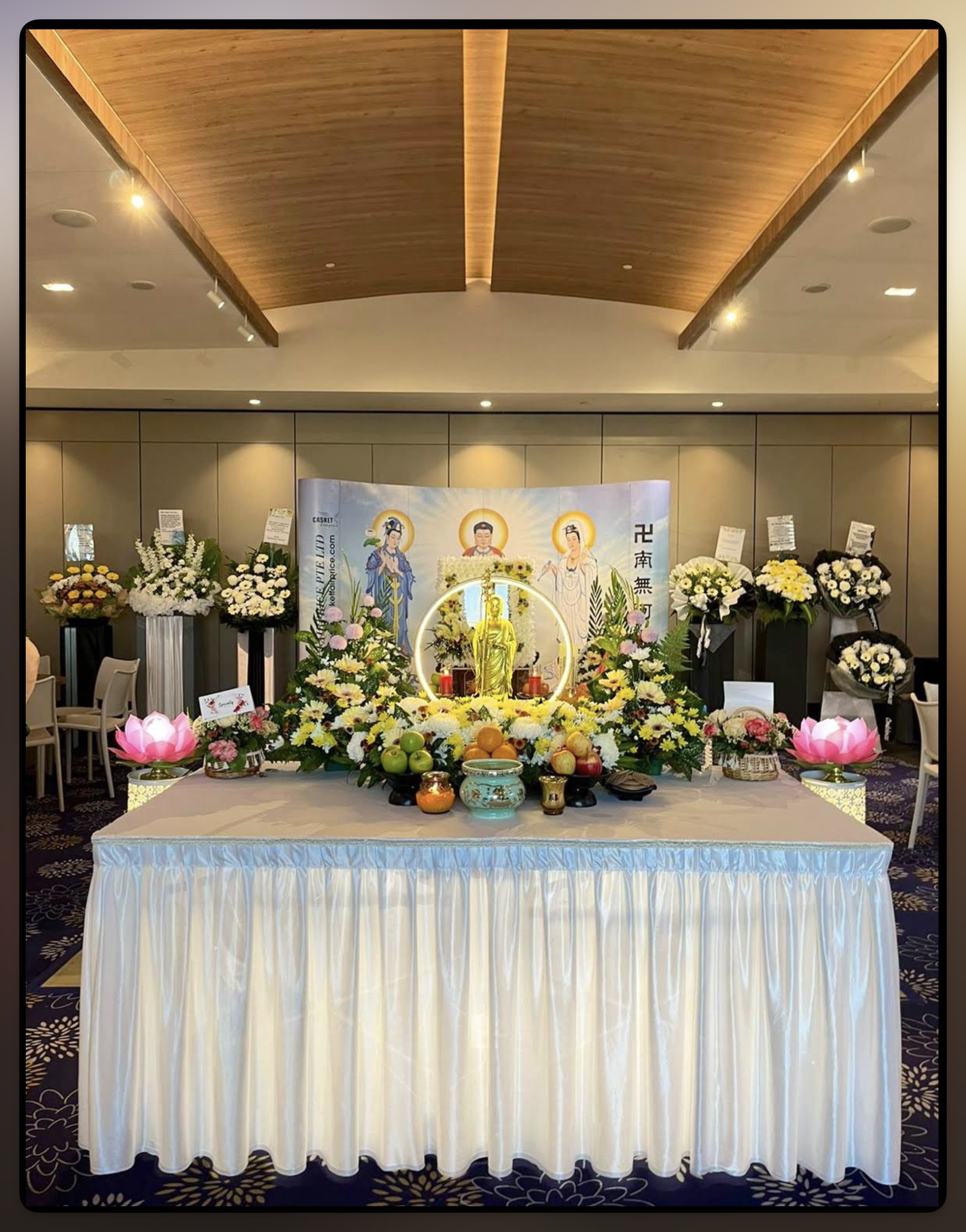 Buddhist memorial altar with a Buddha image, flowers and offerings